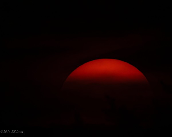 Setting red sun in black frame