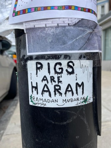 Sticker on a pole that says "Pigs are Haram, Ramadan Mubarak"