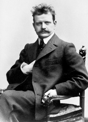 Black and white photo of Jean Sibelius sitting in a chair c. 1898-1900
