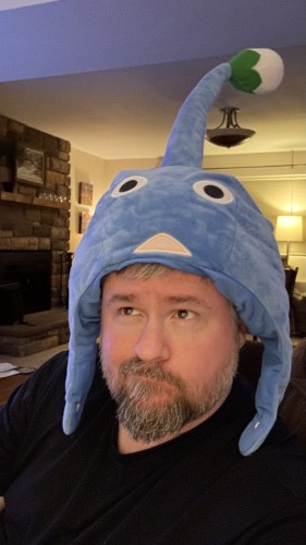 Photo of me wearing a blue Pikmin hat 