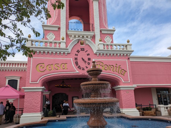 The very pink frontage of Casa Bonita, complete with fountain.