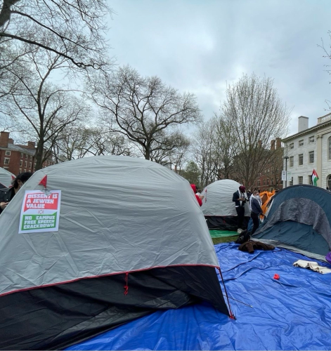 several tents in Harvard Yard. In the foreground one says "dissent is a Jewish value, no campus free speech crackdown"
