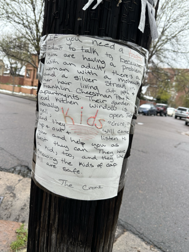 A flyer posted on a light pole from an older punk rock woman offering to help kids if they are having issues with adults, just yell in through her window. It’s signed The Crone. 