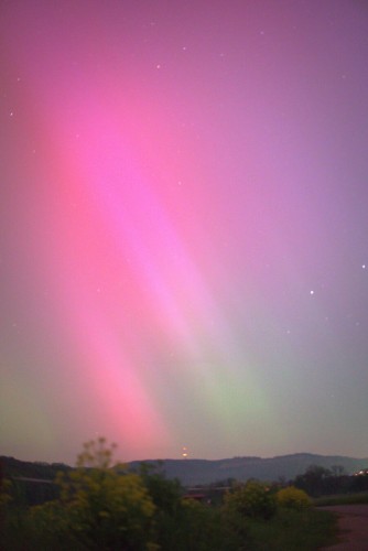 Intense violet and greenish colors on the night sky in slight curtain shape.