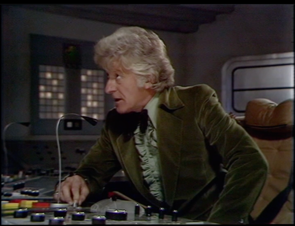 Jon Pertwee talking into a gooseneck microphone on a cargo space ship. From Frontier in Space, 1973.