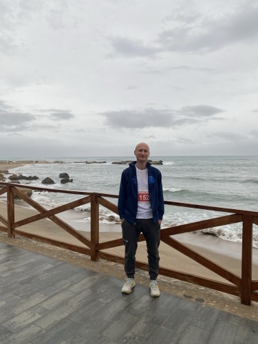 Me standing in front of the Mediterranean. The sky is gray but it’s not raining yet. The sea is angry. 