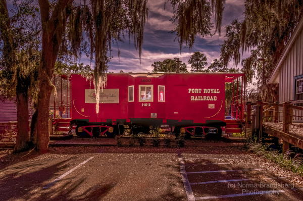 The old red caboose located in Port Royal, South Carolina framed by a bright carolina sky and old moss covered oak tree's, on sale here.

https://www.pictorem.com/1968349/Port%20Royal%20to%20Yemasee%20SC%20Railroad%20Red%20Caboose.html