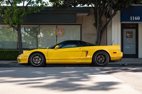 Yellow Japanese sports exotic, street parked.