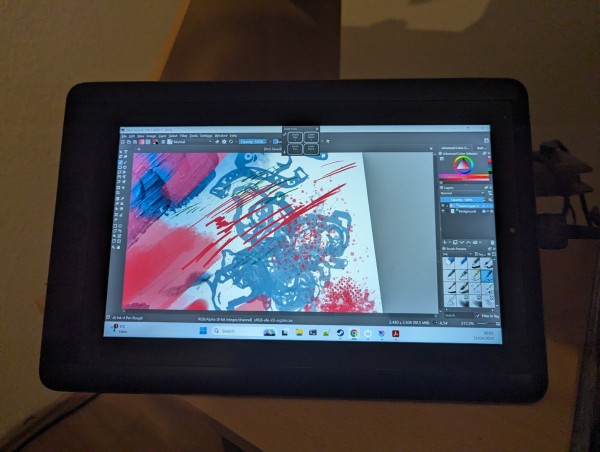 A wacom graphics tablet, displaying various splashes of color in the krita app.