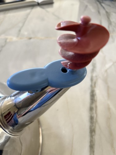 Close-up of a teapot spout that is blue and red