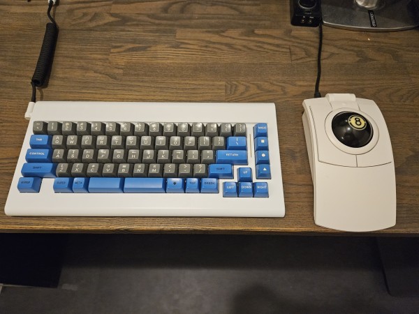 Left: A white CA66 keyboard with keycaps styled after the Symbolics Space Cadet.

Right: A white CST trackball with an 8-ball as its ball.