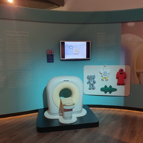 A miniature version of an MRI machine with toys that can be placed in it plus a lot of text in exhibition walls around it. 