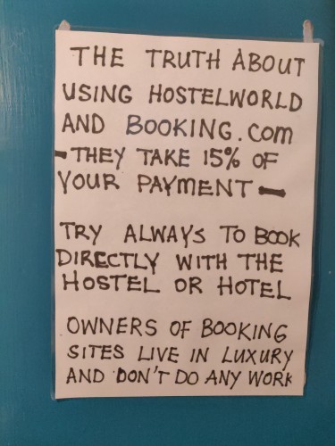 Capitalised text that reads;

"The truth about using HostelWorld and booking.com
- they take 15% of your payment -
Try always to book directly with the hostel or hotel
Owners of booking sites live in luxury and don't do any work"