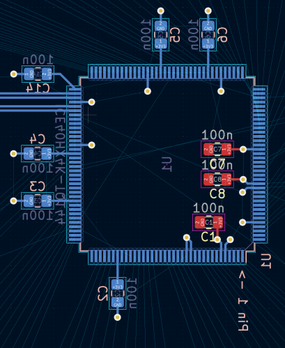 Screenshot of a work-in-progress 2-layer PCB design.  In blue, a TQFP-144 iCE40 and 6 capacitors near the +3V3 pins outside of the footprint.  In red, 3 capacitors inside the footprint connected via vias to +3V3 pins.
