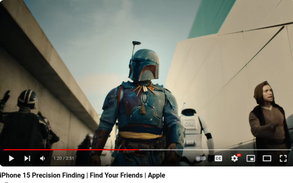 Person in Boba Fett costume walking down some kind of hallway - there is a  window in back that is an odd shape, triangular wall shape next to it