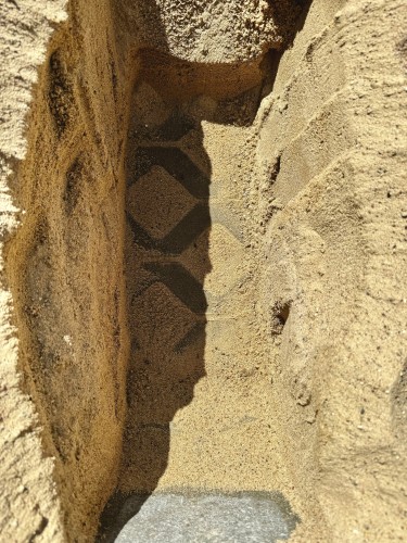 The bottom of the mentioned sandpit.
