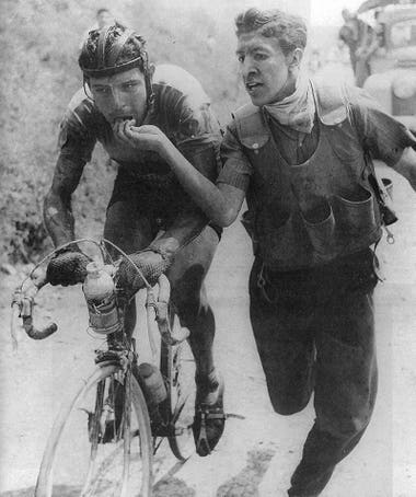 Ricardo Ovalle, at the verge of collapsing, being fed by his soigneur. 1959 Vuelta a Colombia. Photography by Horacio Gil Ochoa