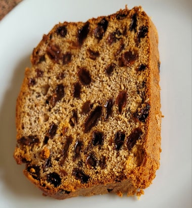 A slice of bara brith on a white plate