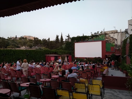 Cinema seats. Blue sky, full moon, acropolis in the background