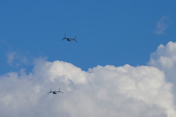 two v22s flying toward a cloud