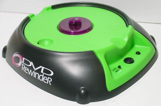 A device called DVD Rewinder. It has a black and green shell, a disc mount, and a button to start.