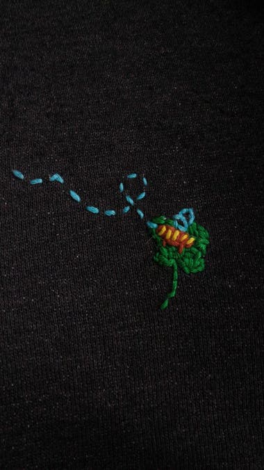 Visible bee on clover mend on black hoody