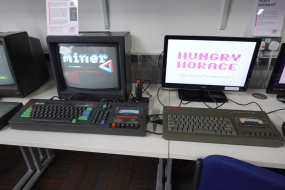 An Amstrad CPC464 running Manic Miner and a Sinclair Spectrum+2 running Hungry Horace