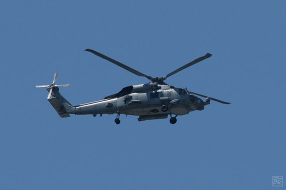 a grey UH-60 seahawk in a blue sky