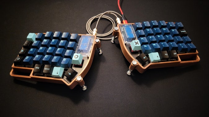 A Lily58 split ergo keyboard, in a 3D-printed, tented case.