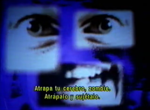 A face made of three different pictures of an eye, andother eye, and a mouth. Text reads "Atrapa tu cerebro, zombi. Atrápalo y sujétalo."