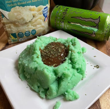 Green mashed potatoes next to a green can of monster energy drink
