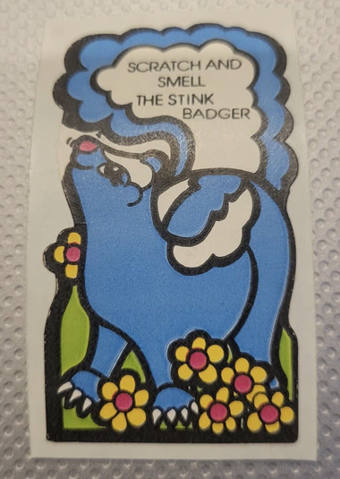 a cartoon illustration of a skunk with the words "scratch and sniff the stink badger"