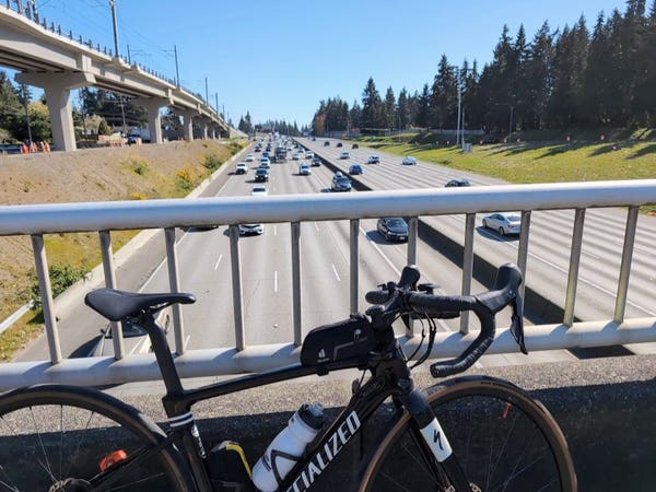 My road bike and me on the 5 freeway overpass looking at the traffic on the freeway