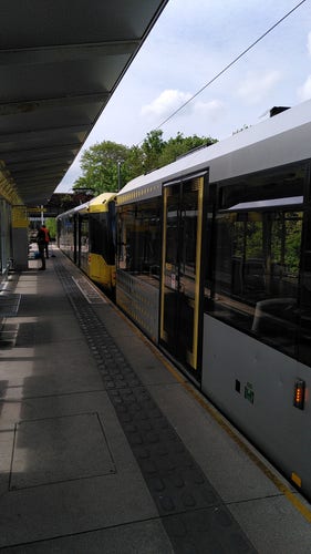 A train/tram on the Manchester Metrolink waiting at East Didsbury station