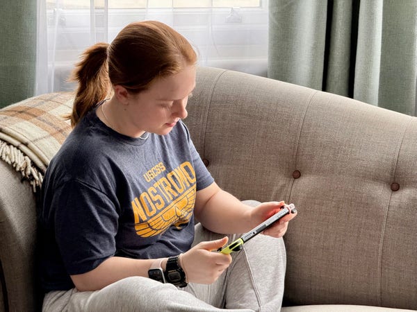 A child playing on a Nintendo Switch. Her T-shirt reads “USCSS Nostromo.”