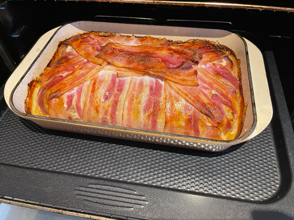 Bacon wrapped stuffing cake halfway baked in the oven