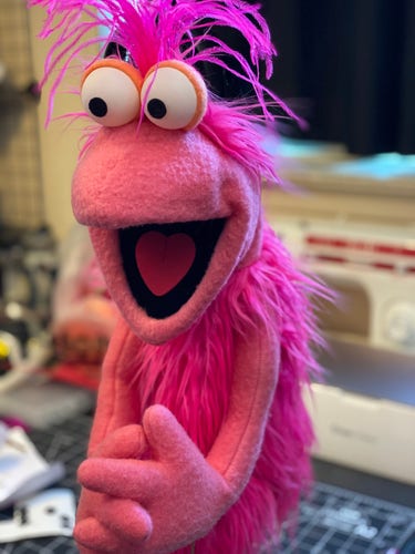 A pink Fraggle-like puppet seen from the front