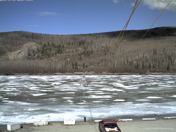 Tuesday afternoon webcam image showing the Tanana River at Nenana and the Ice Classic tripod on the decaying ice. Ropes connect the tripod to the clock in the watch tower. 