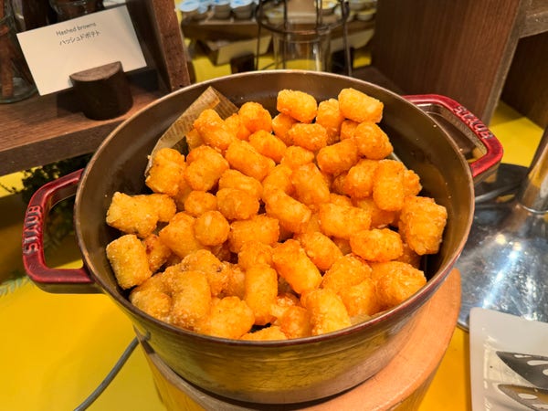 A pot filled with golden-brown tater tots