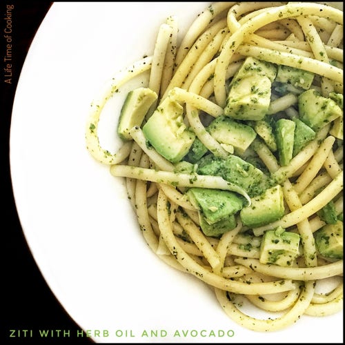 A white plate of ziti pasta mixed with avo and herb-garlic oil.