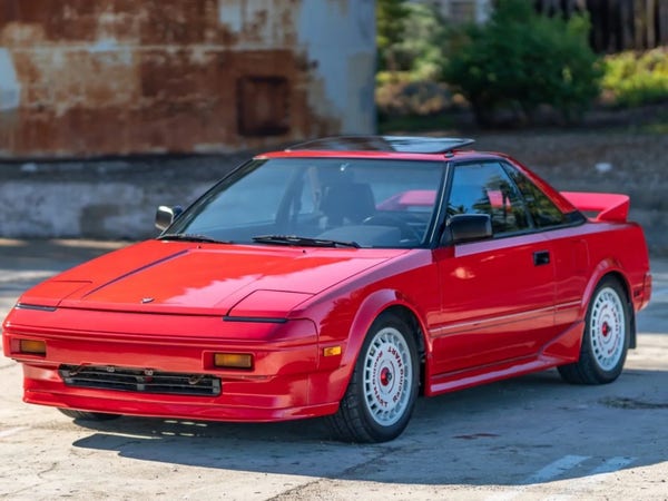 A bright red 80’s sports car with pop-up headlights and the overall appearance of a doorstop: the 1985-1989 Toyota MR2 AW11.