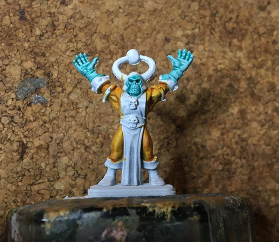 a very early work in progress mini paint job of heroquest's chaos sorcerer. The colours look weird.