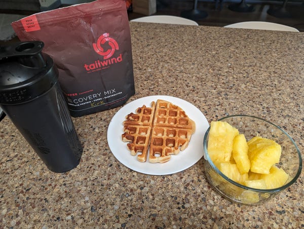 picture of my breakfast which is made up of a recovery mix, a high protein waffle and a pineapple.
it's 219g carbs, 41g protein and 8g fat