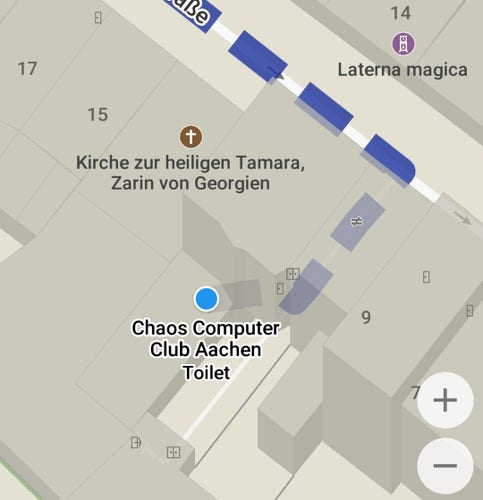 Screenshot of Organic Maps, which sources data from OpenStreetMap. The current location of the user (indicated using a blue-ish circle) is inside a building with the label "Chaos Computer Club Aachen". The label has something like a subtitle / sublabel reading "Toilet".