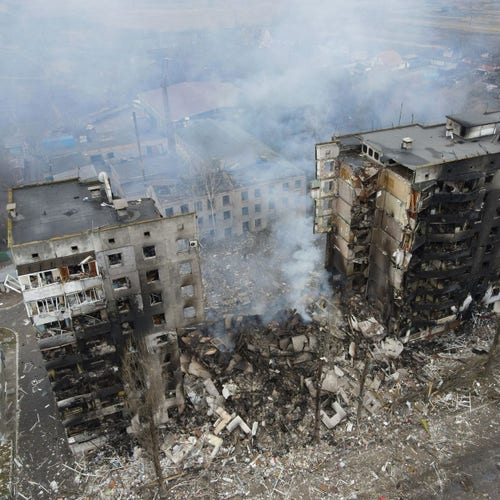 A scene of near-complete urban destruction with buildings in ruins.