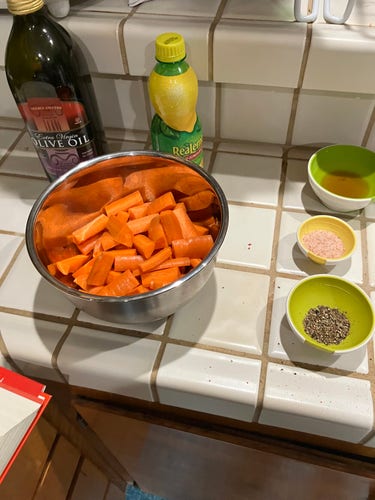 Mise en place: carrot sticks, round pepper, salt, honey & water, reach in a separate prep container. Nearby: bottles of evoo & lemon juice. 