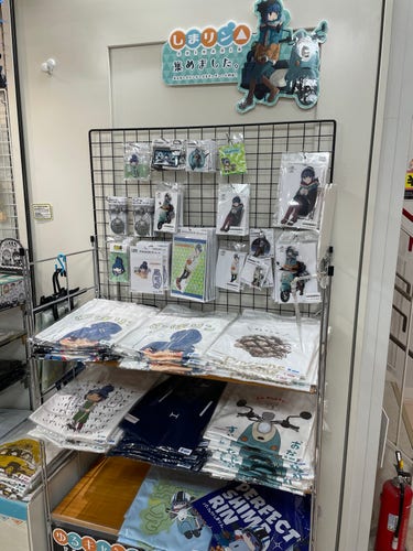 Display of various Laid Back Camp merchandise (shirts, stands, etc.) in a shop in Tokyo (Akihabara) 