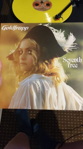 Alison Goldfrapp in a white shirt and French old Nepoleon hat on a vinyl cover with yellow vinyl 