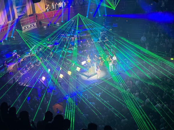 An orchestra at the Royal Albert Hall, but with a dance-event style light show going on with green lasers and the like