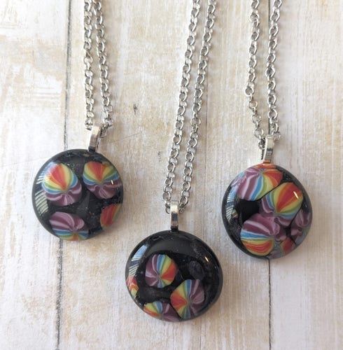 pendants with black background and rainbow foreground 